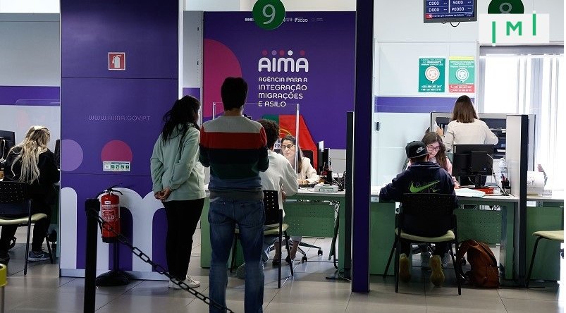 Image of an AIMA office front or a queue of people waiting.