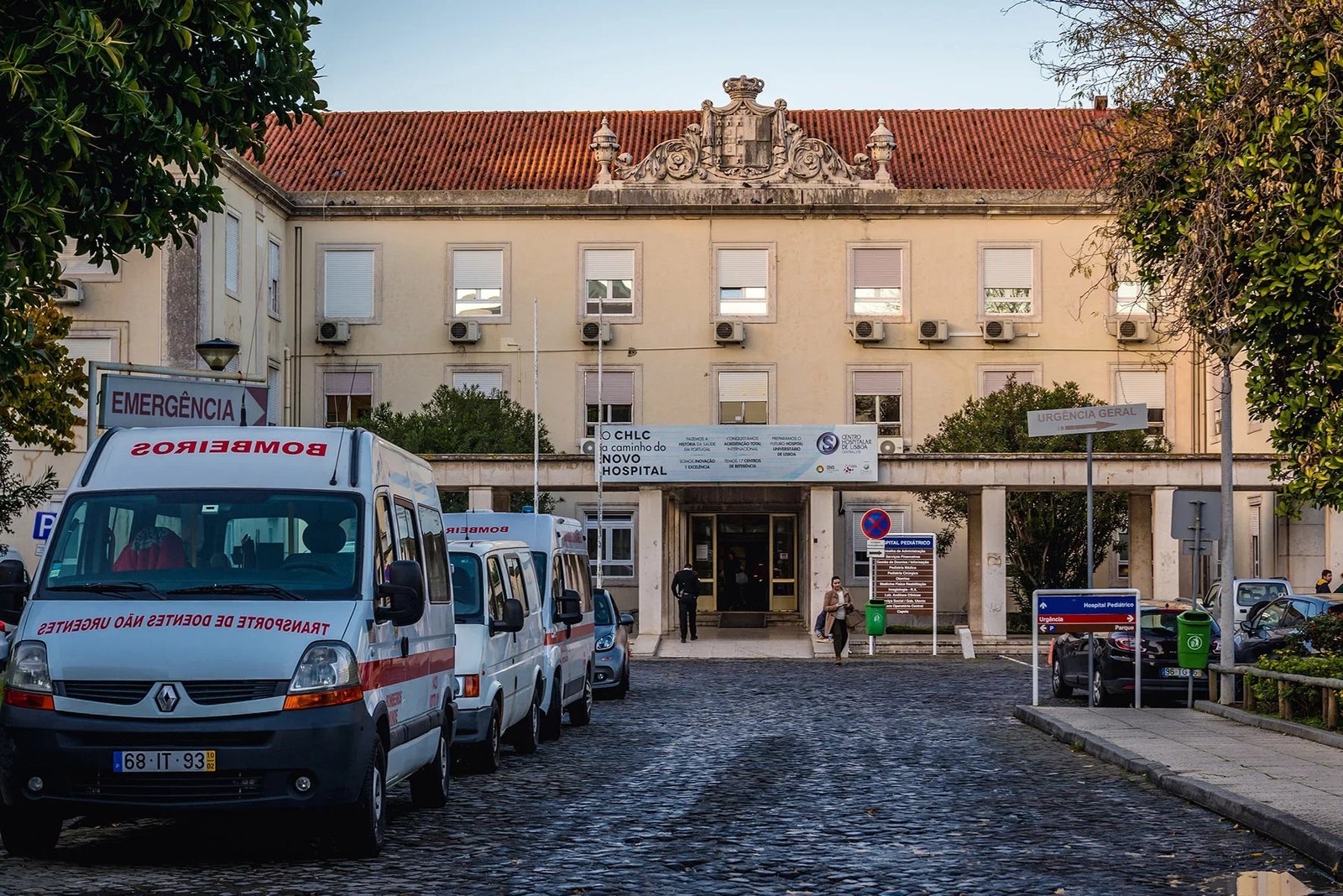 Façade d'un bâtiment public portugais avec les drapeaux du Portugal et de l'UE, représentant un centre de santé.
